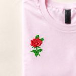 Pink shirt with a rose embroidery design and colorful thread